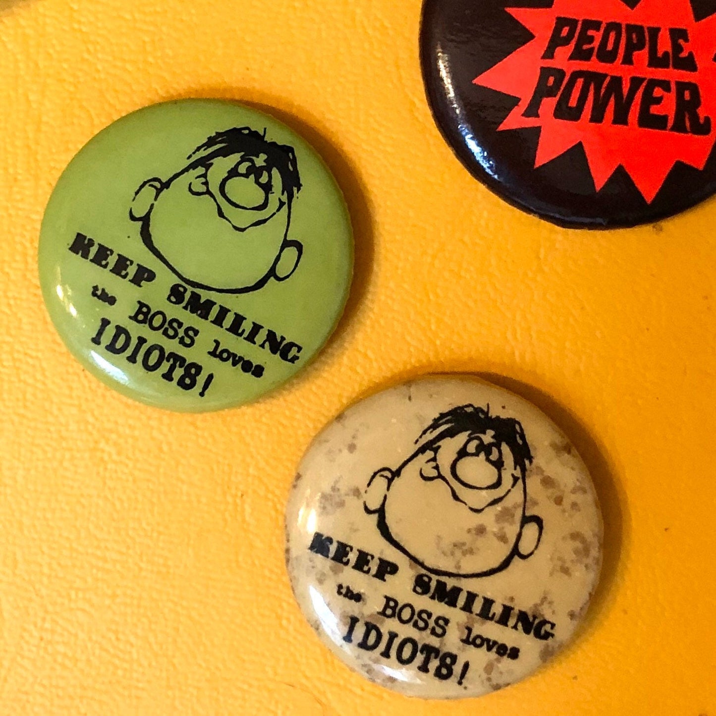 70s “Keep Smiling, the Boss Loves Idiots” buttons