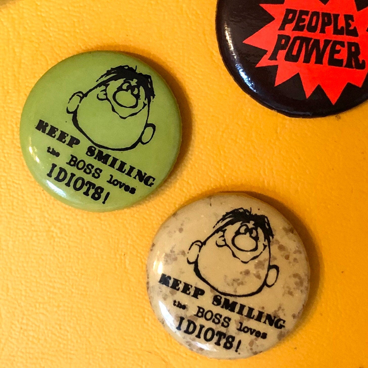 70s “Keep Smiling, the Boss Loves Idiots” buttons